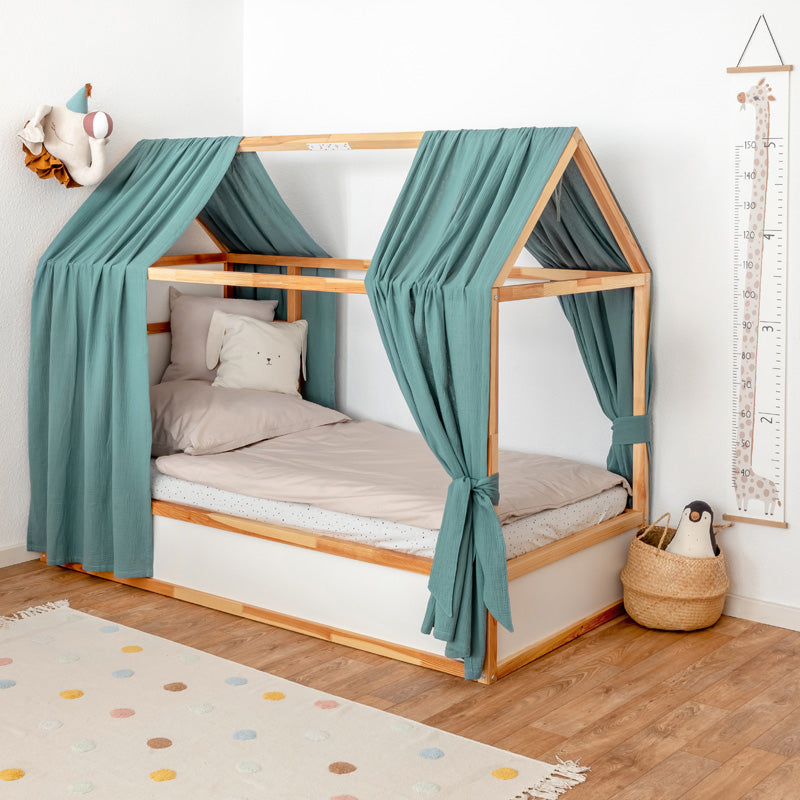 IKEA Kura Baldachine aus grünem Musselinstoff.